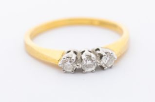 A three stone diamond and 18t gold ring, comprising three round brilliant cut diamonds, total weight