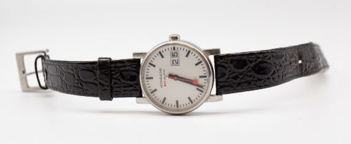 A ladies Mondaine wristwatch, comprising a white sinned round dial, baton indices, date aperture