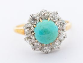 A turquoise and diamond set 18ct gold cluster ring, comprising a round cabochon cut turquoise approx