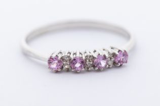 A diamond and pink stone 9ct white gold ring, claw set with seven alternate diamond and pink stones,