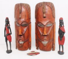 Two mid 20th Century African face wall hardwood masks along with two West African tribal figures.