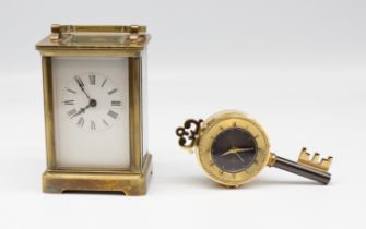 An early 20th Century French brass carriage clock along with a late 20th Century key shaped clock.