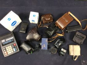 A collection of assorted cameras to include: Canon AE-1 with additional lens; together with