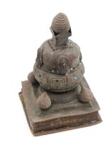 A small copper Buddhist stupa, Nepalese/Tibetan, heavily oxidised and decorated with blue stones.