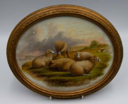 A 20th century oval porcelain plaque depicting Sheep grazing near cliffside, signed indistinctly