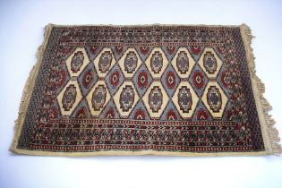 A mid 20th Century hand knotted Persian rug, blue and red ground with medallions and border, 140cm x