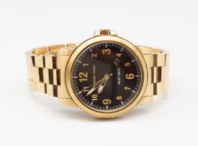 A ladies oversized gold plated Michael Kors wristwatch, comprising round black dial with applied