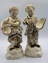 A pair of late 19th/early 20th century French porcelain figures of possibly flower pickers, both