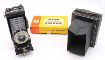 A boxed six-20 folding Brownie camera and a City Sales Exchange camera.