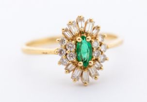 An emerald and diamond 14ct gold oval cluster ring, comprising an marquise mixed cut emerald