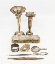 A mixed lot of silver to include two trumpet vases, mirror, napkin rings brush and button hook