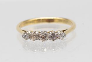 A diamond set 18ct gold ring, comprising five graduated old cut diamonds, total diamond weight