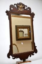 A Georgian fret mirror in carved wooden frame with later glass, approx 95 x 52cm