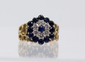 A vintage sapphire and diamond gold ring, comprising a central round mixed cut sapphire within a