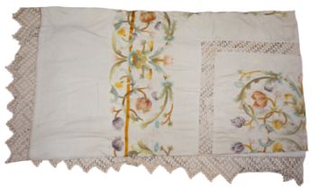 A large cotton twill bedspread, probably 1920s, edged in beige cotton lace, richly embroidered with