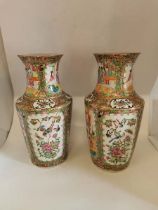 A pair of late 19th century Cantonese Famille Rose vases each approximately 36cm high. In good