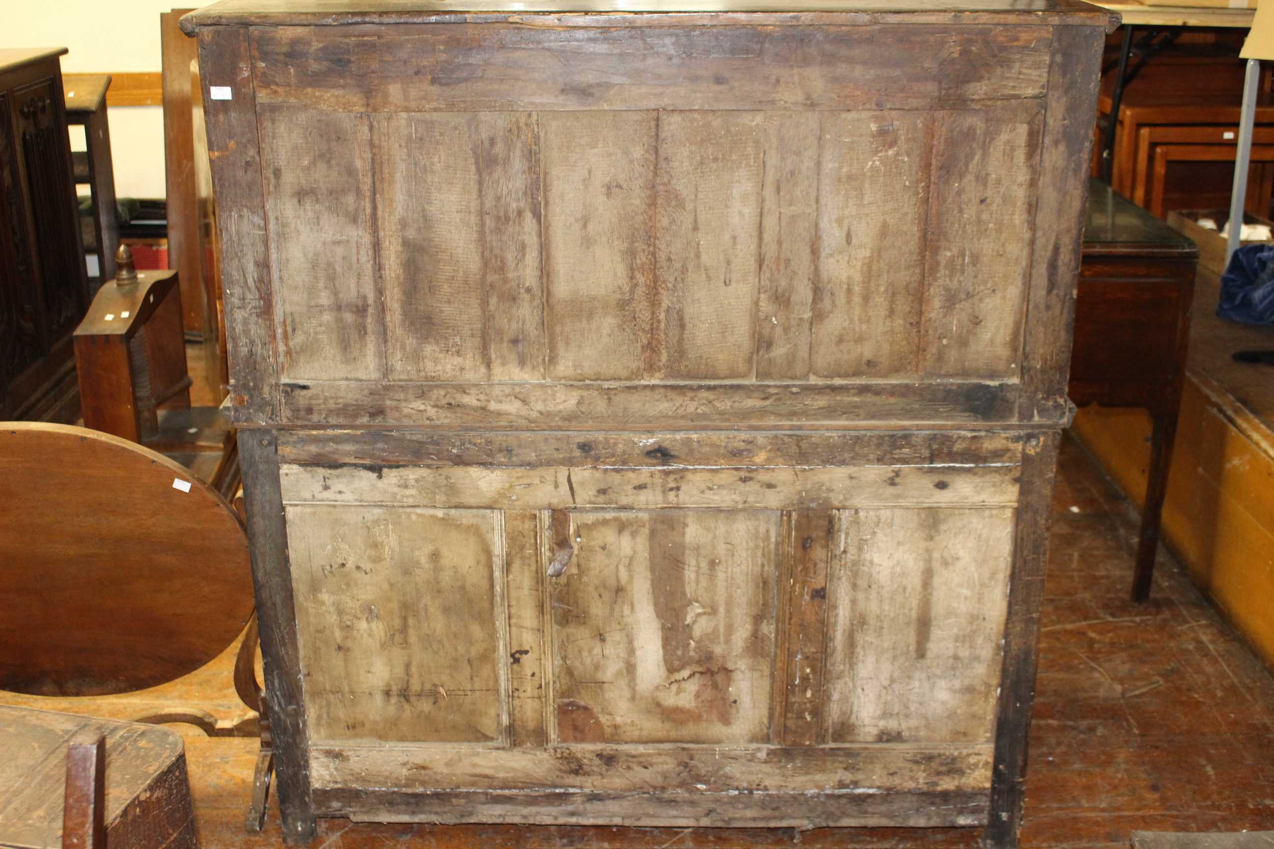 A 17th Century and later panelled oak cupboard, the upper section with moulded edge above a pair - Image 4 of 4