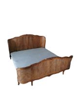 A 20th century French style walnut and rattan cane work super king size bed and mattress. (1)