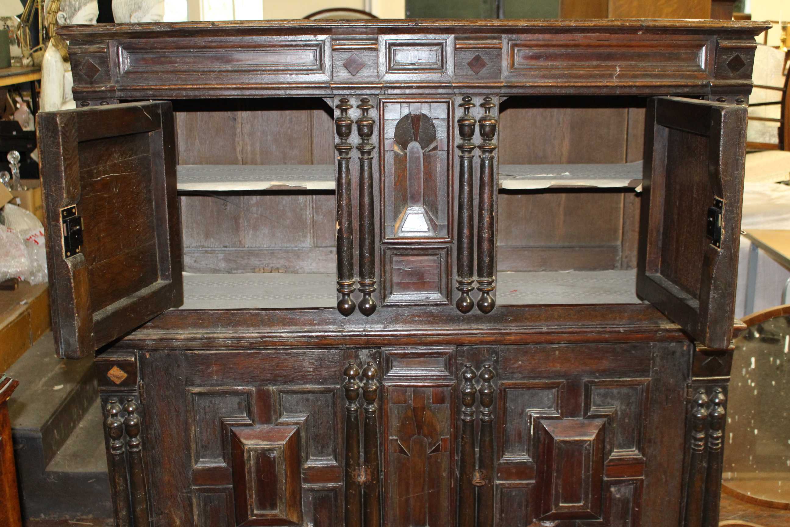 A 17th Century and later panelled oak cupboard, the upper section with moulded edge above a pair - Image 2 of 4