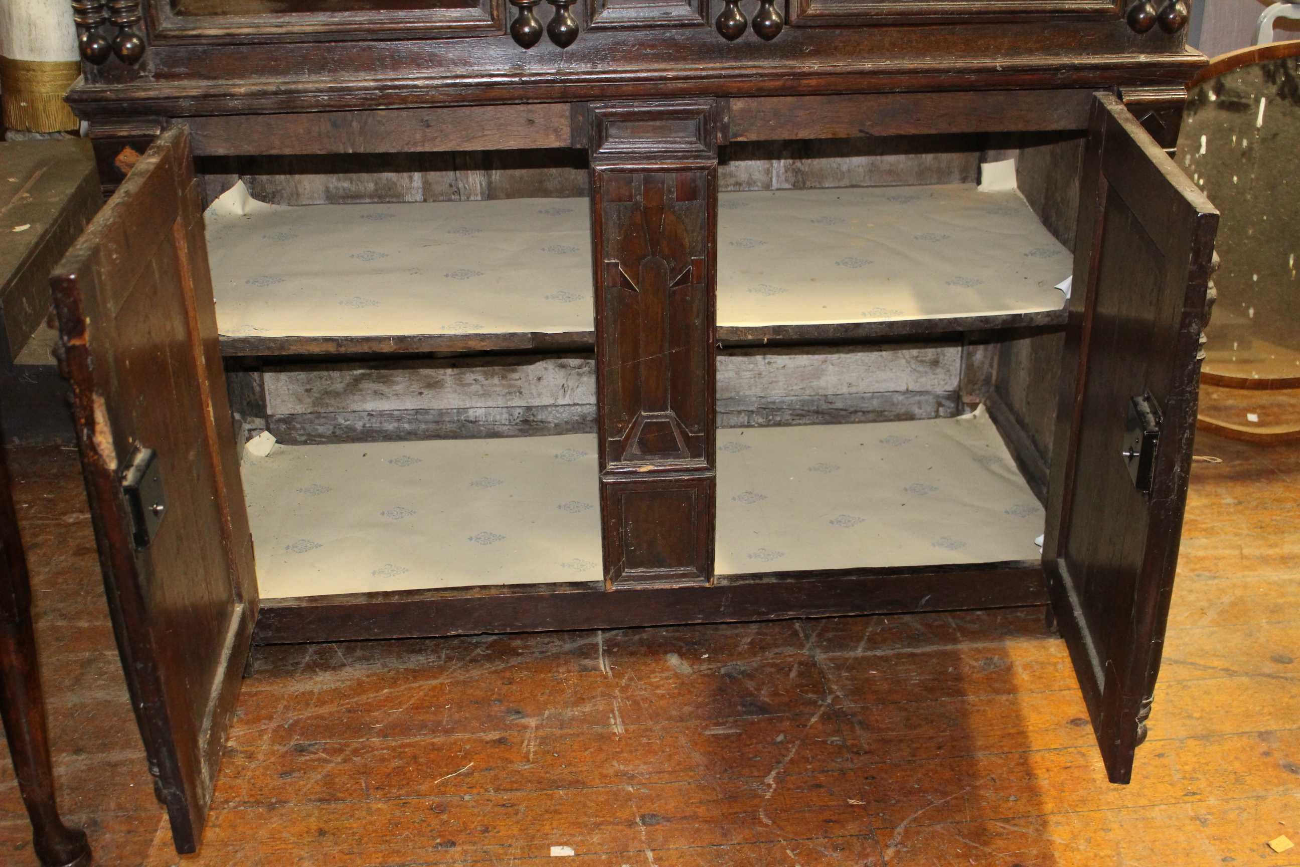 A 17th Century and later panelled oak cupboard, the upper section with moulded edge above a pair - Image 3 of 4