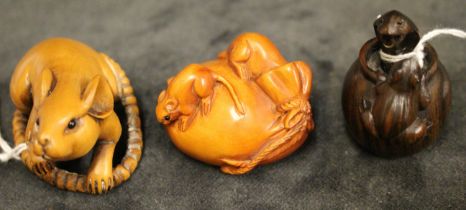 Three modern Japanese carved wood netsuke, one modelled as a rat with long tail, 5cm long, another