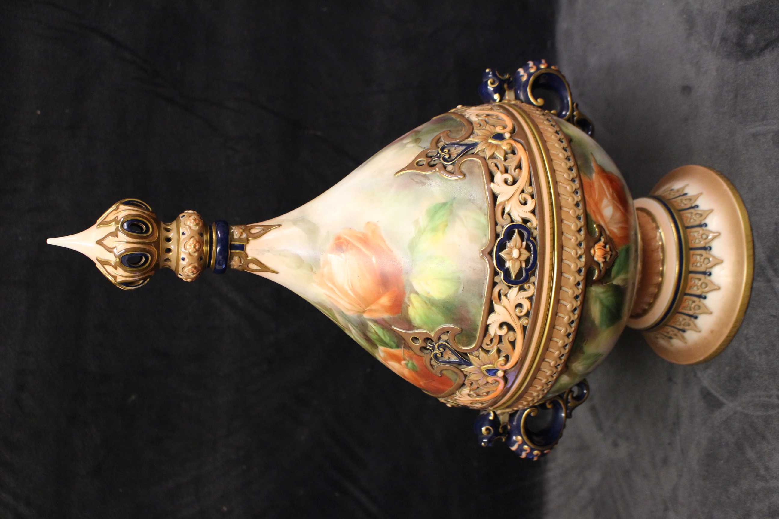 A Hadley's Worcester twin-handled pot pourri and cover painted with roses, the pierced cover and