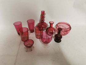 A collection of cranberry glass to include Edward VII commemorative, beakers and vases etc. (10)