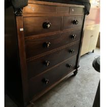 Chest of 2 short over three long drawers in mahogany with unusual ceramic centred knobs, supported