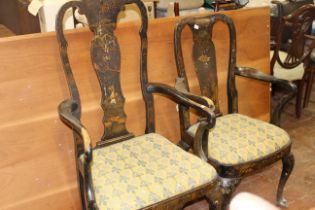 Two George II style black lacquer open armchairs with shaped top rail and splats, drop in needlework