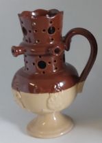 A Bourne Denby Stoneware coloured puzzle jug C1900. Standing 21 cm tall  Condition: Good