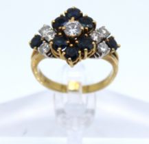 18ct Yellow Gold Sapphire & Diamond dress ring.  There is a centre Round Brilliant Cut Diamond