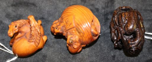 Three modern Japanese carved wood netsuke modelled as three rats and a nut, signed, 4.5cm wide, a