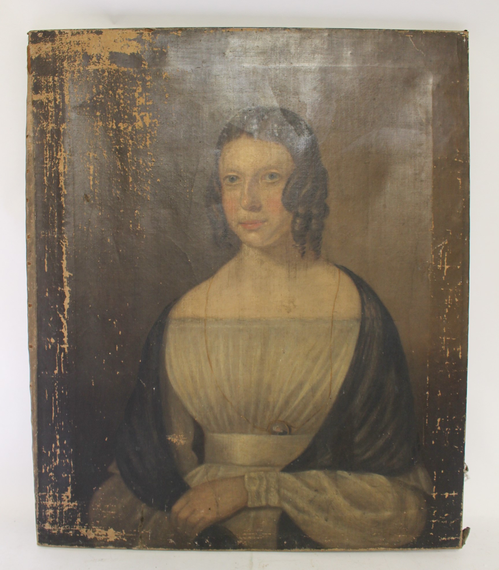 Early 19th British naive school Portrait of a young lady, half length, her hair in ringlets and