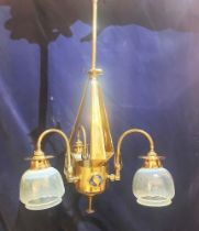 A Brass Arts and Crafts ceiling hanging light with yellow Vaseline shades with 3 Ruskin style