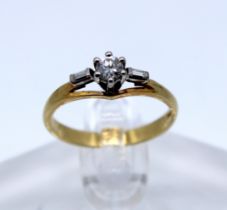 18ct Yellow Gold 0.20ct Round Brilliant Cut Diamond ring with Baguette Cut Diamonds on shoulders