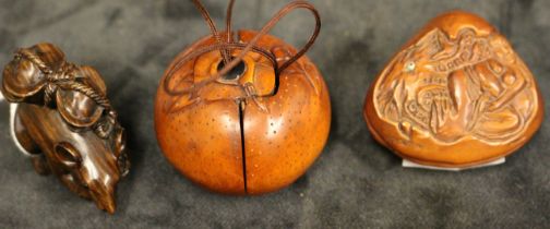 Three modern carved wood Netsuke modelled as Hotei's sack, the interior with two puppies, 4.5cm