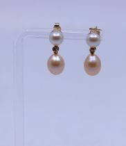 14ct Gold Cultured Pearl and Diamond Droplet Earrings. There is a Round Cultured Pearl and a Baroque