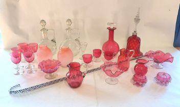 A collection of Victorian and later Ruby glass items and a pair of clear glass decanters, along with