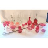 A collection of Victorian and later Ruby glass items and a pair of clear glass decanters, along with
