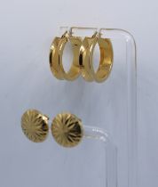 Two pairs of 9ct Gold Earrings. There is a pair of 9ct Gold Hoop Earrings. Each Hoop Earring