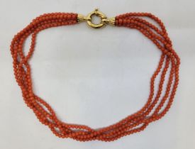 A four strand pink coral bead necklace, with 18ct. gold clasp, length 47.5cm. (gross weight 53.2g)