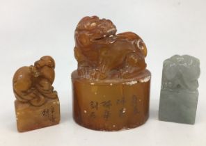 Three Chinese carved hardstone seals, two with character marks engraved to side, the largest