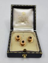 Three 9ct. gold and sapphire dress shirt studs, Birmingham 1965, each engine turned with mixed round
