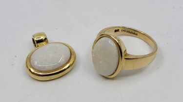 A 9ct. gold and opal ring, set oval cabochon opal, size UK P+, together with a matching 9ct. gold