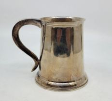 A silver tankard, London 1927, of traditional tapering form, height 12cm. (351.4g)