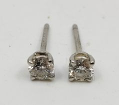 A pair of Tiffany & Co platinum diamond stud earrings, each set single round brilliant cut
