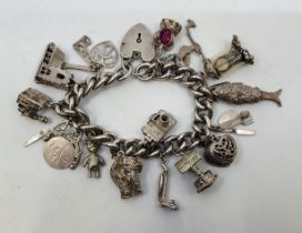 A silver charm bracelet, with silver heart padlock clasp, the silver curb link bracelet suspending