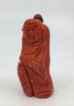A Chinese carved pink coral scent bottle, carved as a standing figure, height with stopper 7.