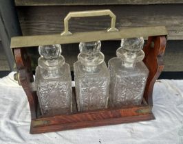 A 19th cent oak cased tantalus and a silver plated decanter set