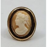 A yellow metal cameo ring, the oval carved shell cameo of a lady in left profile, size UK L 1/2. (
